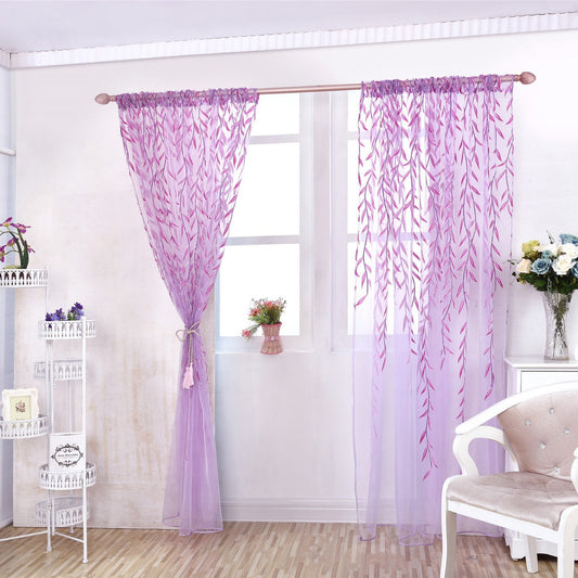Purple leaf-patterned curtains in a room with a chair and shelves.